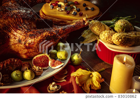 Close-up holiday decorated table with roasted turkey and season traditional vegetables. Thanksgiving day, national traditions Close-up holiday decorated table with roasted turkey and season traditional vegetables. Thanksgiving day, national traditions 83010862