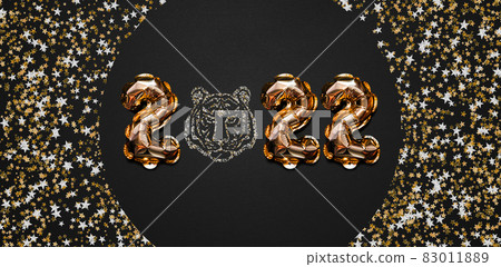 Happy New year 2022 celebration. Bright gold balloons figures, New Year Balloons with glitter stars on dark background. Christmas celebration. Gold foil balloons With symbol of the year of the Tiger Happy New year 2022 celebration. Bright gold balloons figures, New Year Balloons with glitter stars on dark background. Christmas celebration. Gold foil balloons With symbol of the year of the Tiger 83011889