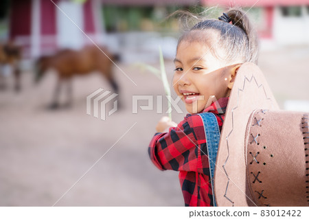 A farmer girl is happily raising animals. 83012422