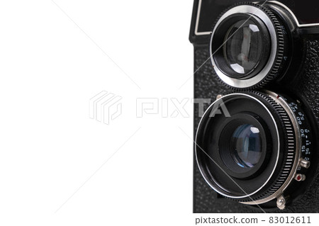 part of a black vintage camera with two lenses on a white background, copyspace part of a black vintage camera with two lenses on a white background, copyspace 83012611