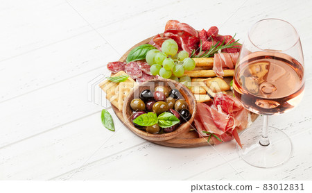 Antipasto board with prosciutto, salami, crackers, cheese, olives Antipasto board with prosciutto, salami, crackers, cheese, olives 83012831