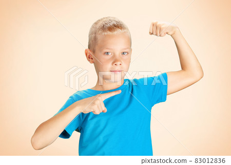 Funny boy showing his biceps muscles Funny boy showing his biceps muscles 83012836