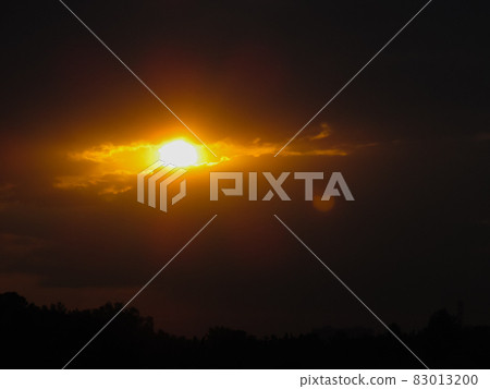 the shape of the sun and clouds looks like a burning eye in the sky 83013200