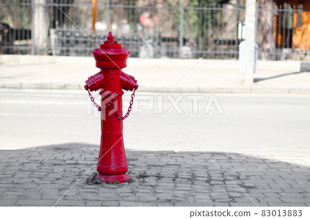 Close up of red fire hydrant on a city street 83013883