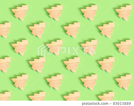 Beautiful pattern of the handmade wooden fir tree on the green background. Beautiful pattern of the handmade wooden fir tree on the green background. 83013889