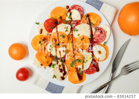 Fresh classic italian caprese salad with sliced red yellow tomatoes, mozzarella, olive oil, pepper and salt on light background. Healthy vegetarian diet food Fresh classic italian caprese salad with sliced red yellow tomatoes, mozzarella, olive oil, pepper and salt on light background. Healthy vegetarian diet food 83014257