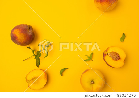 Ripe juicy peaches on yellow background. Flat lay, top view, copy space. Frame made of fresh peashes. Ripe juicy peaches on yellow background. Flat lay, top view, copy space. Frame made of fresh peashes. 83014279