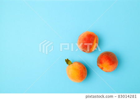 Flat lay composition with fresh peaches on blue background. Fresh organic fruit vegan food. Harvest concept Flat lay composition with fresh peaches on blue background. Fresh organic fruit vegan food. Harvest concept 83014281