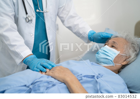 Doctor help Asian senior or elderly old lady woman patient wearing a face mask in hospital for protect safety infection and kill Covid19 Coronavirus. Doctor help Asian senior or elderly old lady woman patient wearing a face mask in hospital for protect safety infection and kill Covid19 Coronavirus. 83014532