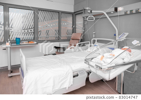 Newborn baby sleeping in the hospital bed 83014747