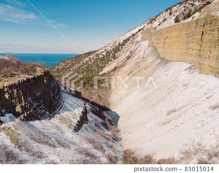 Canyon with snow in winter. Aerial view of canyon in sunny day Canyon with snow in winter. Aerial view of canyon in sunny day 83015014