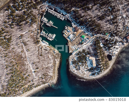 Harbor with sailboats and blue water with snow in winter. Aerial view of sea and mountains Harbor with sailboats and blue water with snow in winter. Aerial view of sea and mountains 83015018