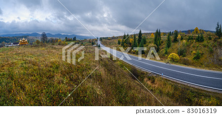 Hazy and overcast Carpathian Mountains and highway on mountain pass, Ukraine. Hazy and overcast Carpathian Mountains and highway on mountain pass, Ukraine. 83016319