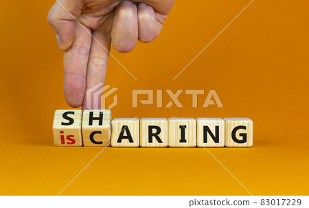 Sharing is caring symbol. Businessman turns wooden cubes with words 'sharing is caring'. Beautiful orange table, orange background. Business, sharing is caring concept. Copy space. Sharing is caring symbol. Businessman turns wooden cubes with words 'sharing is caring'. Beautiful orange table, orange background. Business, sharing is caring concept. Copy space. 83017229
