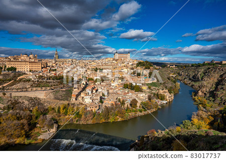 Toledo, Spain. Old city with its Royal Palace over the Tagus River sinuosity 83017737