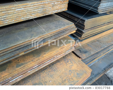 stacks of thick rusted flat metal sheets - close-up 83017788