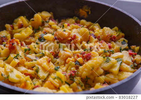 roasted domestic potatos in a frying pan close-up background 83018227