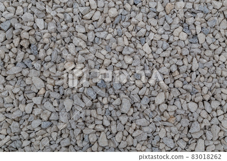 Dry white limestone ballast flat full frame background. Small gray dusty broken macadam stones texture. Dry white limestone ballast flat full frame background. Small gray dusty broken macadam stones texture. 83018262