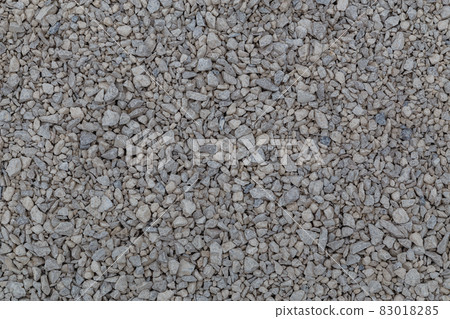 Dry white limestone ballast flat full frame background. Small gray dusty broken macadam stones texture. Dry white limestone ballast flat full frame background. Small gray dusty broken macadam stones texture. 83018285