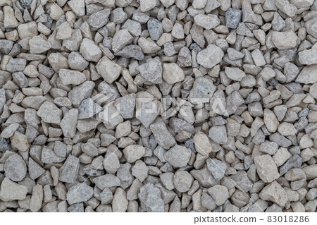 Dry white limestone ballast flat full frame background. Small gray dusty broken macadam stones texture. 83018286