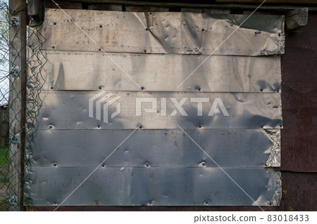 horizontal shiny stainless steel sheets nailed to flat surface 83018433