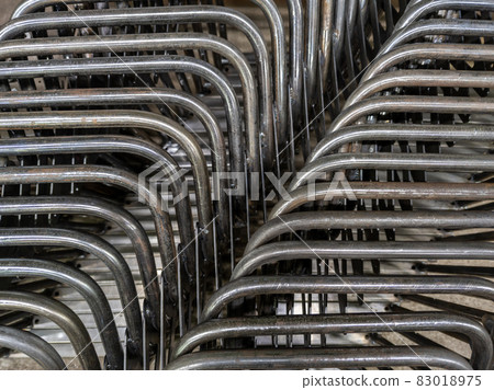 industrial background of bent steel pipes - close-up with selective focus 83018975