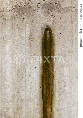 Weeping hole with slurry stain on a concrete retention wall. Close-up. Weeping hole with slurry stain on a concrete retention wall. Close-up. 83019033