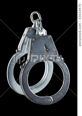 real zinc plated steel police handcuffs closed, isolated on black background real zinc plated steel police handcuffs closed, isolated on black background 83019470