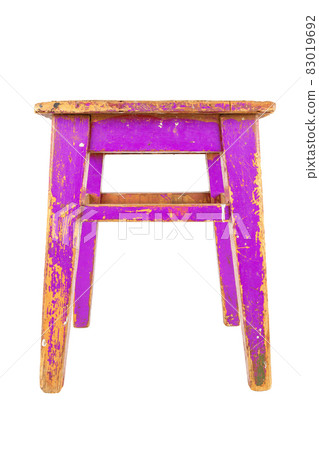 Old wooden stool with peeling pink paint. Loft style chair isolated on a white background. Old wooden stool with peeling pink paint. Loft style chair isolated on a white background. 83019692