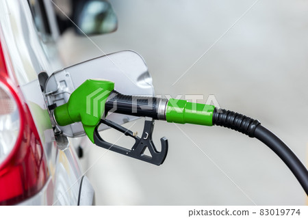 Silver car refuelling at the gas station, the concept of fuel energy Silver car refuelling at the gas station, the concept of fuel energy 83019774