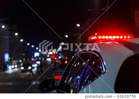 police car lights in night city with selective focus and bokeh police car lights in night city with selective focus and bokeh 83019776