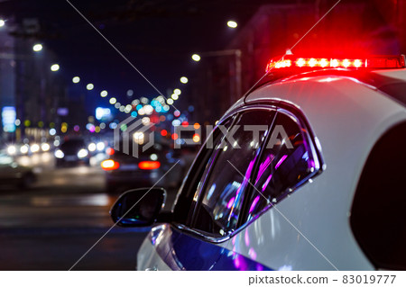 police car lights in night city with selective focus and bokeh police car lights in night city with selective focus and bokeh 83019777