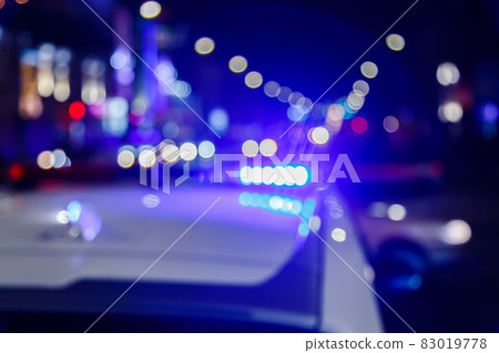 defocused photo of police car lights in night city with selective focus and bokeh defocused photo of police car lights in night city with selective focus and bokeh 83019778