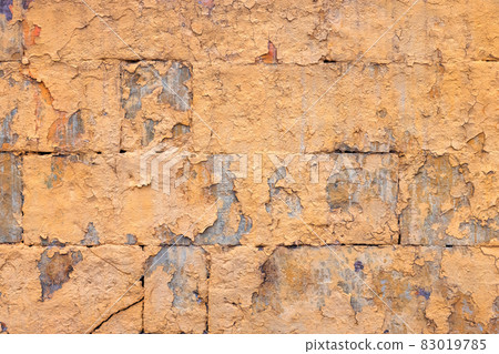 peeled off old orange paint on flat rough brick wall surface - full frame background and texture peeled off old orange paint on flat rough brick wall surface - full frame background and texture 83019785