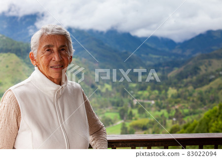 Senior woman at the beautiful view point over the Cocora Valley in Salento, located on the region of Quindio in Colombia 83022094