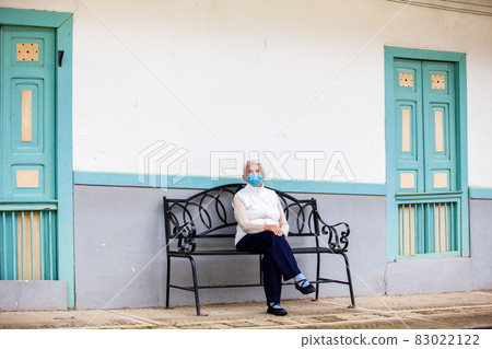Senior woman traveling at the beautiful small town of Salento, located on the region of Quindio in Colombia Senior woman traveling at the beautiful small town of Salento, located on the region of Quindio in Colombia 83022122