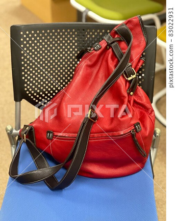 Red bag on a blue chair 83022931