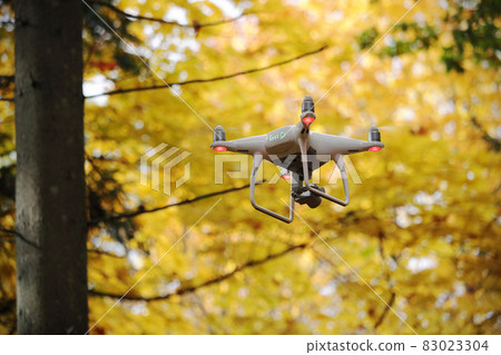 Flying drone in autumn yellow forest environment 83023304