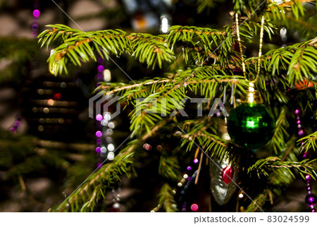 Christmas toys against the background of green branches and lights Christmas toys against the background of green branches and lights 83024599