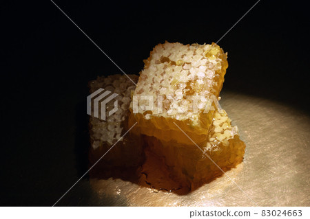sweet organic honey on dark background sweet organic honey on dark background 83024663