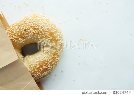 bagel and paper packet on white background bagel and paper packet on white background 83024744