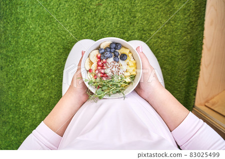 Pregnant woman eating healthy food. Organic calcium salad. Fruits and microgreen 83025499