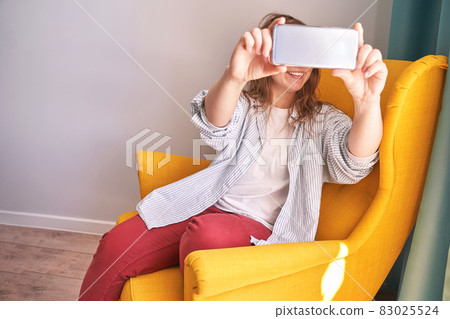 Young woman doing self portrait indoors. Home vacation portrait. Blogger selfie 83025524