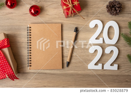 2022 New Year with notebook, Christmas gift and pen on wood table. Xmas, Happy New Year, Goals, Resolution, To do list, start, Strategy and Plan concept 83028879