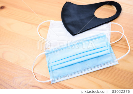 Various masks on the table Cloth mask Non-woven mask New coronavirus infection prevention measures Disinfection and sterilization prevention 83032276