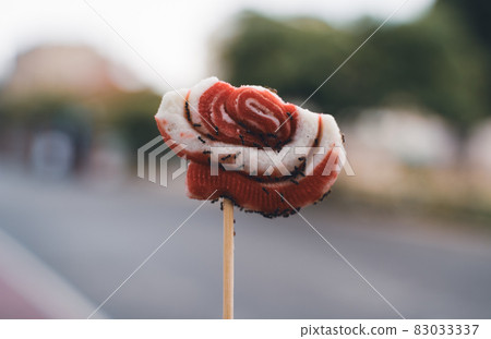 many ants eating from a lollipop on a stick many ants eating from a lollipop on a stick 83033337
