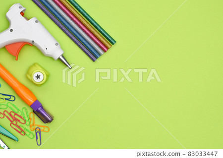 Tools and stationery items for creativity on green background. 83033447
