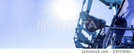 Side-by-side backhoe and blue sky image 83034680