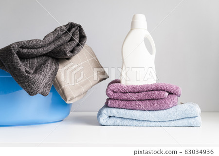 front view pile towels with laundry softener. High quality and resolution beautiful photo concept front view pile towels with laundry softener. High quality and resolution beautiful photo concept 83034936