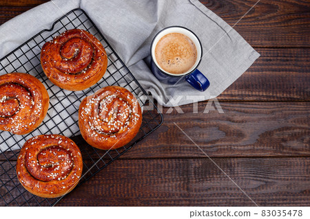 Swedish cinnamon buns Kanelbulle with cup of coffee or cappuccino, wooden background, copy space Swedish cinnamon buns Kanelbulle with cup of coffee or cappuccino, wooden background, copy space 83035478